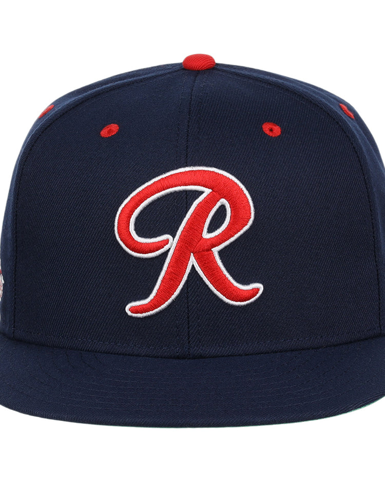 The Seattle Rainiers EFF MiLB Vintage Snapback by Ebbets Field Flannels features a navy blue design, bold red and white R on the front, red accents, flat brim, and is part of the Vintage Minor League collection.