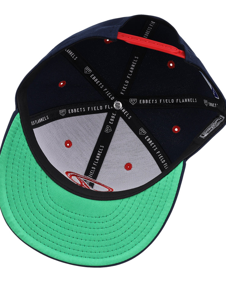 The Seattle Rainiers EFF MiLB Vintage Snapback by Ebbets Field Flannels features a green underbrim, black interior panels with Ebbets Field Flannels branding, red button accents, and a red adjustable strap at the back.