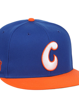 The Charlotte Orioles EFF MiLB Vintage Snapback by Ebbets Field Flannels features a blue crown, orange bill, bold white-and-orange C front logo, and a 2003 patch—ideal for Cal Ripken Jr. fans and vintage baseball collectors.