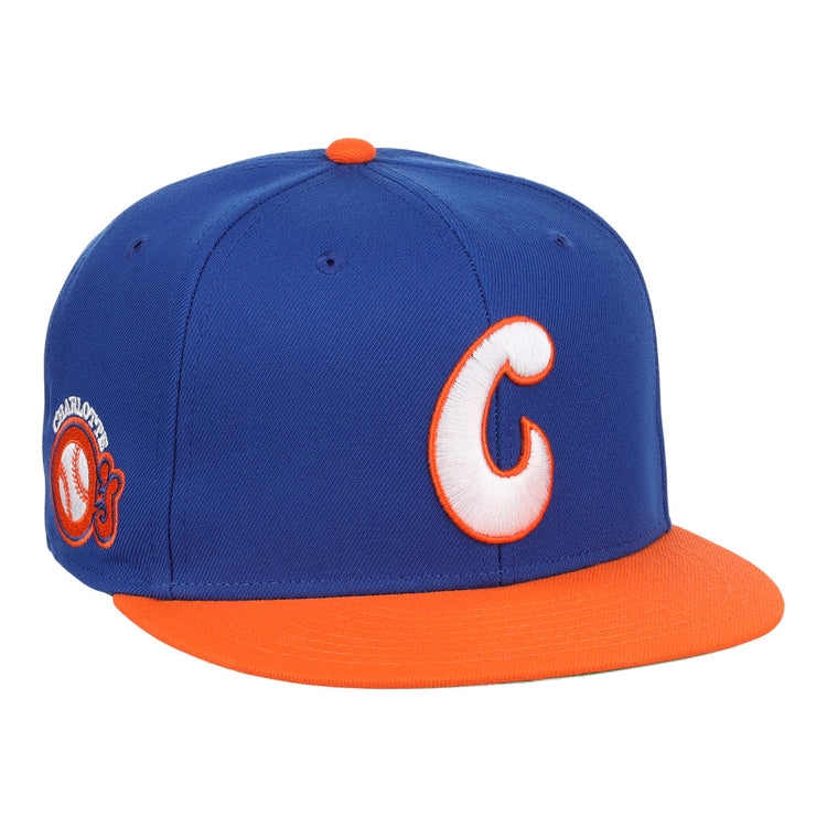 The Charlotte Orioles EFF MiLB Vintage Snapback by Ebbets Field Flannels features a blue crown, orange bill, bold white-and-orange C front logo, and a 2003 patch—ideal for Cal Ripken Jr. fans and vintage baseball collectors.