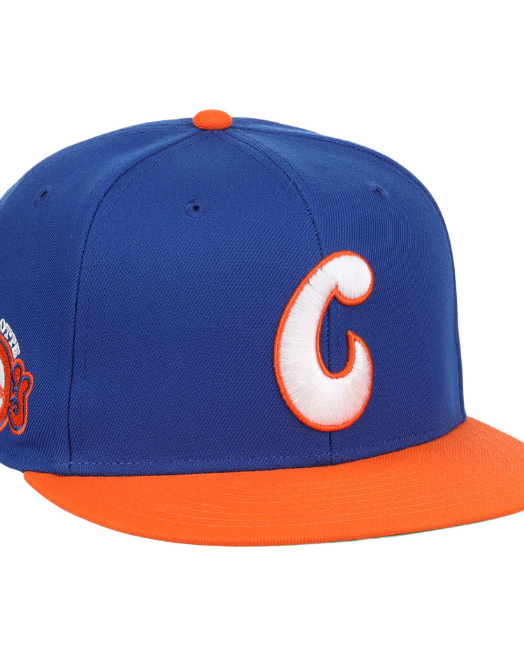 The Charlotte Orioles EFF MiLB Vintage Snapback by Ebbets Field Flannels features a blue crown, orange bill, bold white-and-orange C front logo, and a 2003 patch—ideal for Cal Ripken Jr. fans and vintage baseball collectors.