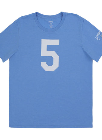 The Ebbets Field Flannels George Brett Hall of Fame T-Shirt is a light blue short-sleeve tee with a large white number 5, white text, and small flag patches on the left sleeve, inspired by the Kansas City Royals legend.