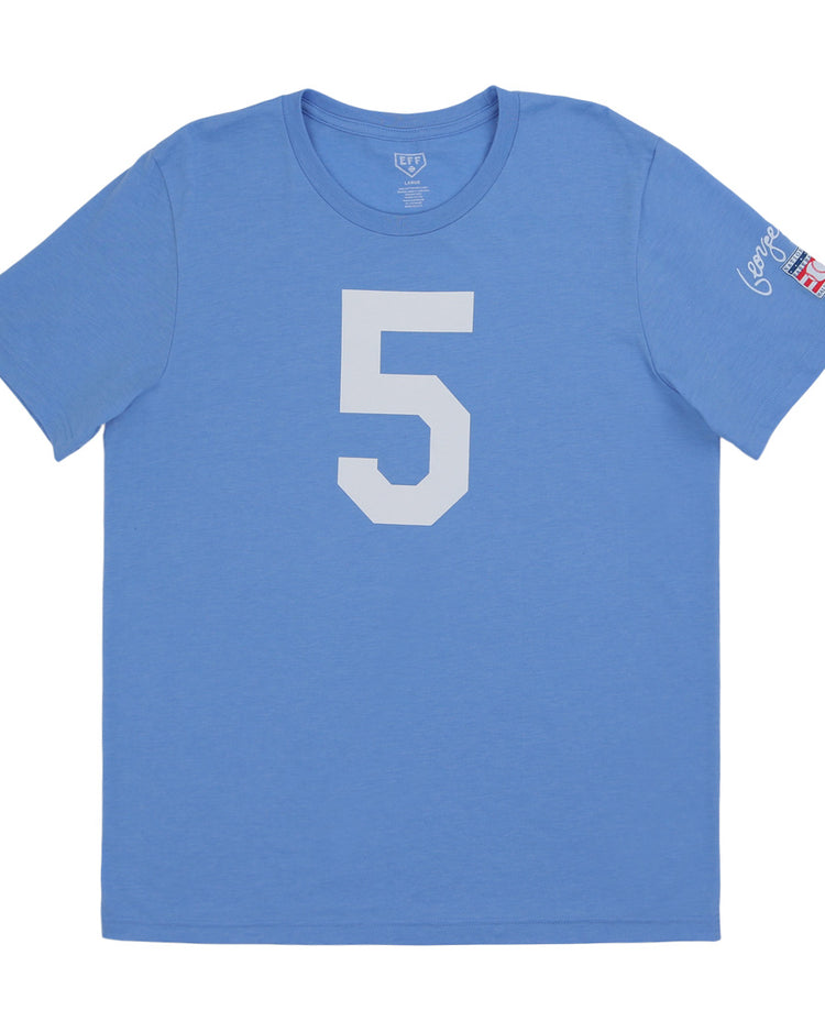 The Ebbets Field Flannels George Brett Hall of Fame T-Shirt is a light blue short-sleeve tee with a large white number 5, white text, and small flag patches on the left sleeve, inspired by the Kansas City Royals legend.