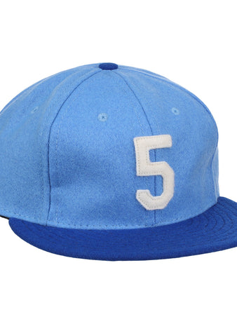 The Ebbets Field Flannels George Brett Signature Series Ballcap features vintage light blue wool, a dark blue brim, and a white number 5 on the front, inspired by classic styles from the National Baseball Hall of Fame.