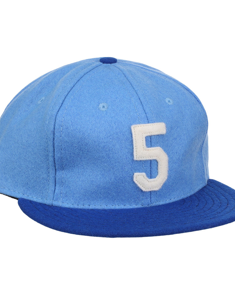 The Ebbets Field Flannels George Brett Signature Series Ballcap features vintage light blue wool, a dark blue brim, and a white number 5 on the front, inspired by classic styles from the National Baseball Hall of Fame.