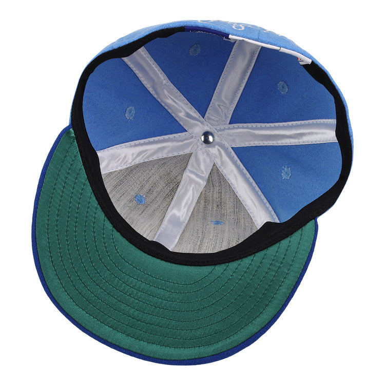The interior of the George Brett Signature Series Ballcap by Ebbets Field Flannels features white seams, a green underbrim, and a small metal button at the top center.