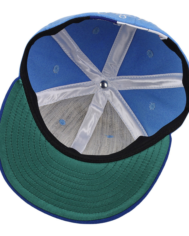 The interior of the George Brett Signature Series Ballcap by Ebbets Field Flannels features white seams, a green underbrim, and a small metal button at the top center.