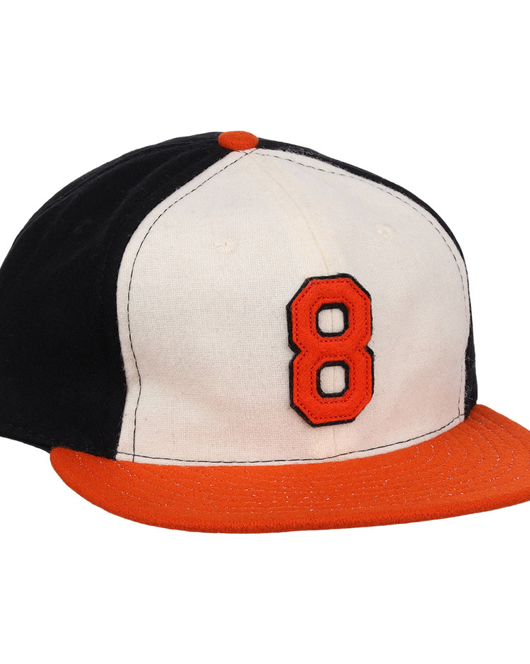 The Ebbets Field Flannels Cal Ripken Jr. Signature Series Ballcap features a vintage design with a black back, white front, orange brim and button, plus a bold orange number 8 outlined in black as tribute to Cal Ripken Jr.