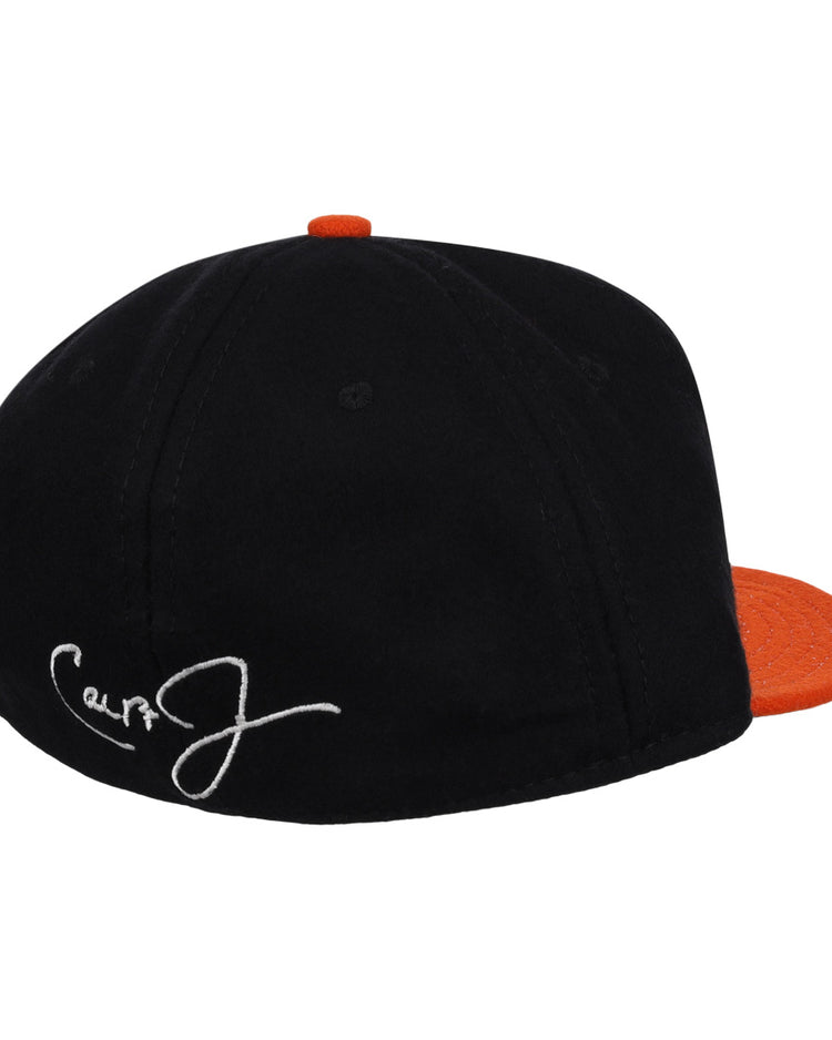 The Ebbets Field Flannels Cal Ripken Jr. Signature Series Ballcap is a black vintage wool cap with an orange brim and button, plus a white embroidered signature on the back—a tribute to Cal Ripken Jr. and the National Baseball Hall of Fame.