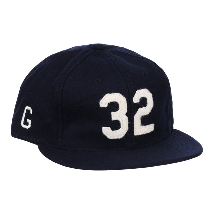 The Buck Leonard Signature Series Ballcap by Ebbets Field Flannels is a vintage navy wool cap with bold white 32 on the front and a white G on the side, honoring Buck Leonard’s legacy in the Negro Leagues.