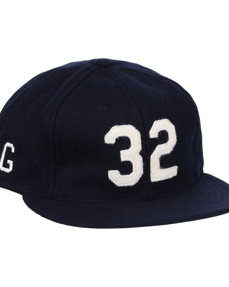 The Buck Leonard Signature Series Ballcap by Ebbets Field Flannels is a vintage navy wool cap with bold white 32 on the front and a white G on the side, honoring Buck Leonard’s legacy in the Negro Leagues.