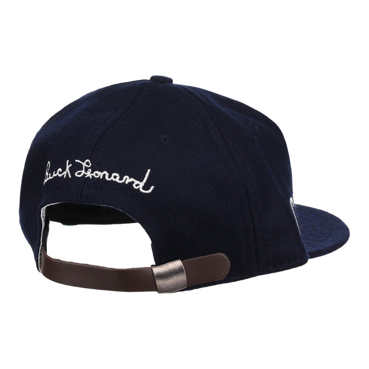 The Buck Leonard Signature Series Ballcap by Ebbets Field Flannels is a navy vintage wool cap seen from the back, with white cursive Buck Leonard embroidery and an adjustable brown strap with metal clasp honoring the Negro Leagues legend.