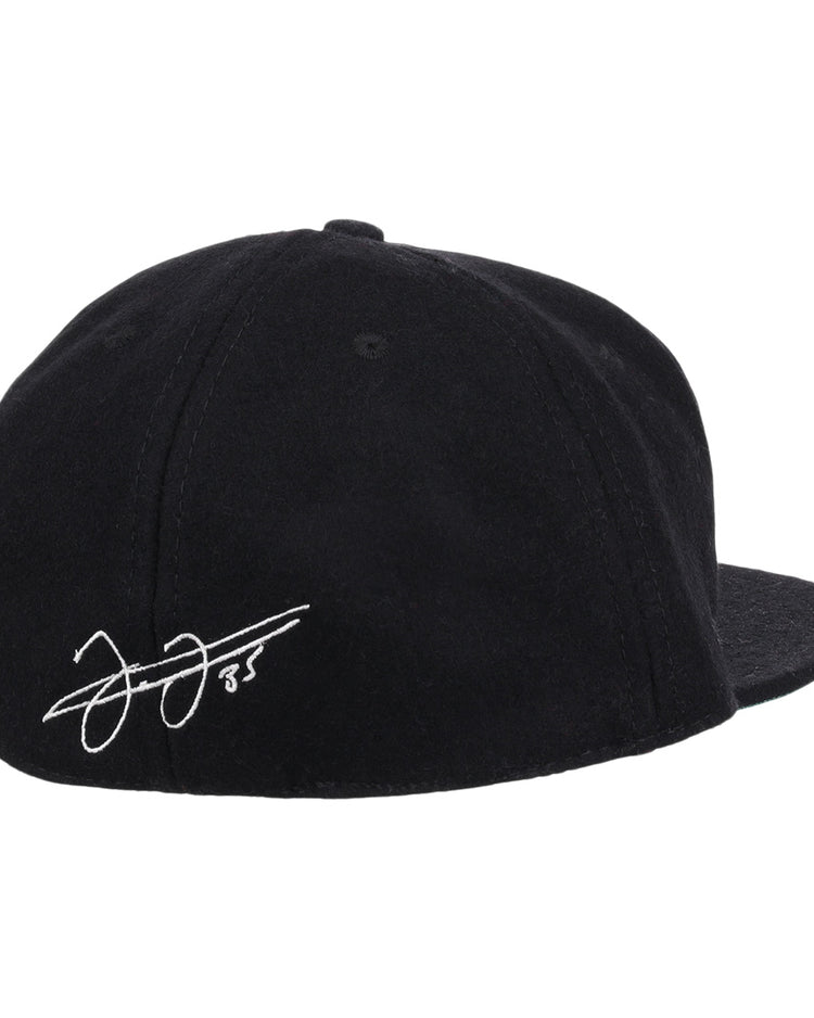 The Frank Thomas Signature Series Ballcap by Ebbets Field Flannels is a black vintage wool cap, seen from the back, with a white Frank Thomas signature and the number 85 on the left side above the brim.