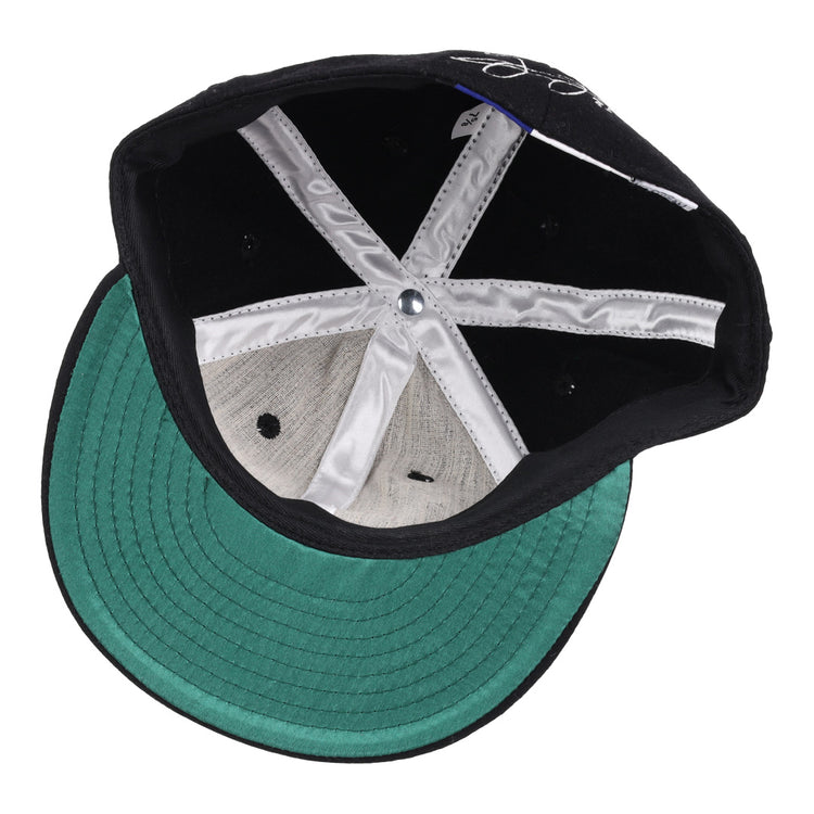 Inside view of the Ebbets Field Flannels Frank Thomas Signature Series Ballcap - Black features a green brim, white lining, black ventilation holes, and a silver crown button.