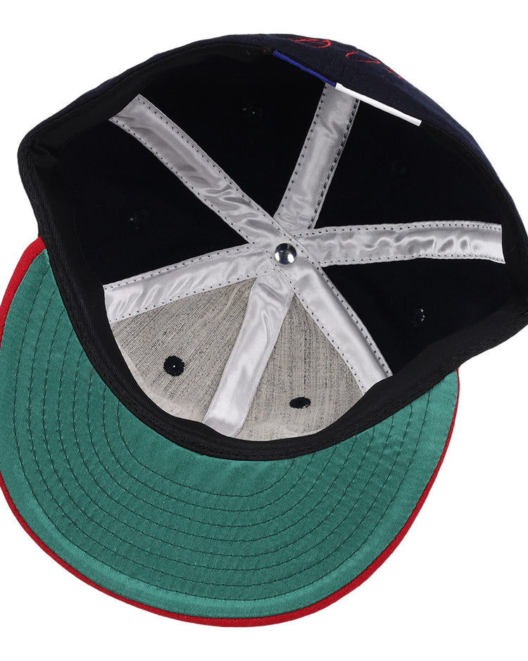 Inside view of the Ebbets Field Flannels Frank Thomas Signature Series Ballcap - Navy, featuring a green underbrim, red edge trim, black interior, white satin taping, and a metallic crown button—a Chicago White Sox classic.