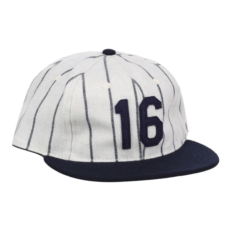 The Ebbets Field Flannels Whitey Ford Signature Series Ballcap is a vintage-style white wool cap with navy vertical pinstripes, a navy brim, and the number 16 in bold navy on the front.