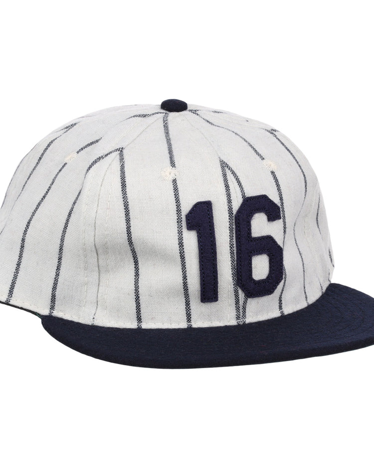 The Ebbets Field Flannels Whitey Ford Signature Series Ballcap is a vintage-style white wool cap with navy vertical pinstripes, a navy brim, and the number 16 in bold navy on the front.