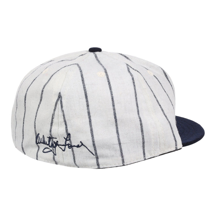 The Ebbets Field Flannels Whitey Ford Signature Series Ballcap features vintage wool, thin navy pinstripes, a solid navy brim, and a black autograph on the side inspired by Whitey Ford’s iconic cap style.