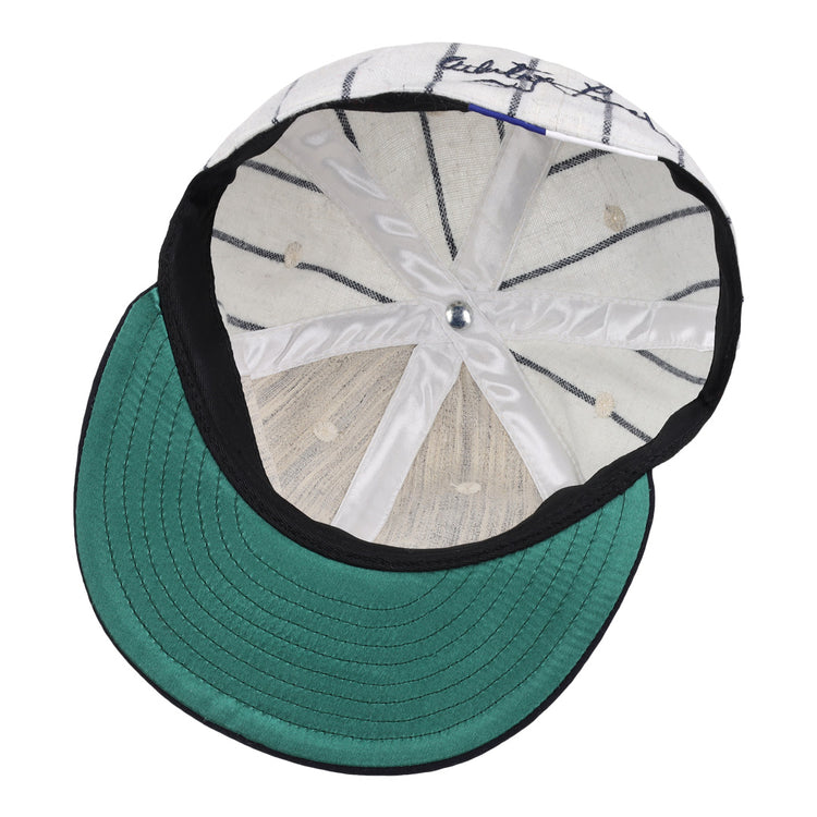 The underside of the Ebbets Field Flannels Whitey Ford Signature Series Ballcap features a green brim, white interior with black pinstripes, silver top button, and visible stitching—hallmarks of authentic vintage Yankees style.