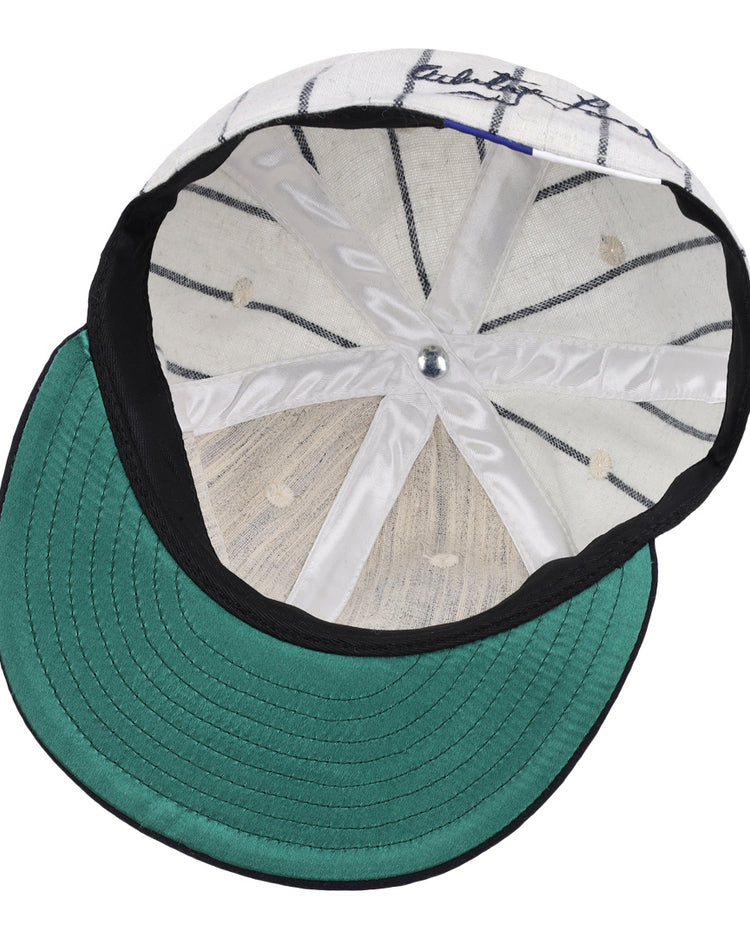 The underside of the Ebbets Field Flannels Whitey Ford Signature Series Ballcap features a green brim, white interior with black pinstripes, silver top button, and visible stitching—hallmarks of authentic vintage Yankees style.