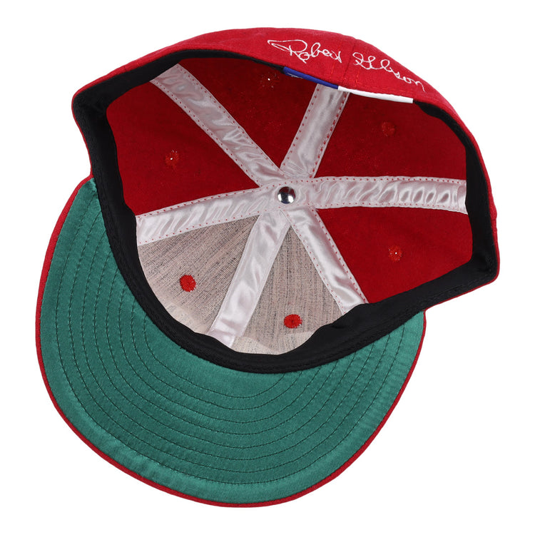 The Bob Gibson Signature Series Ballcap by Ebbets Field Flannels features vintage wool, a green brim, white inner stitching, center metallic button, and a white signature on the inner red section above the brim.