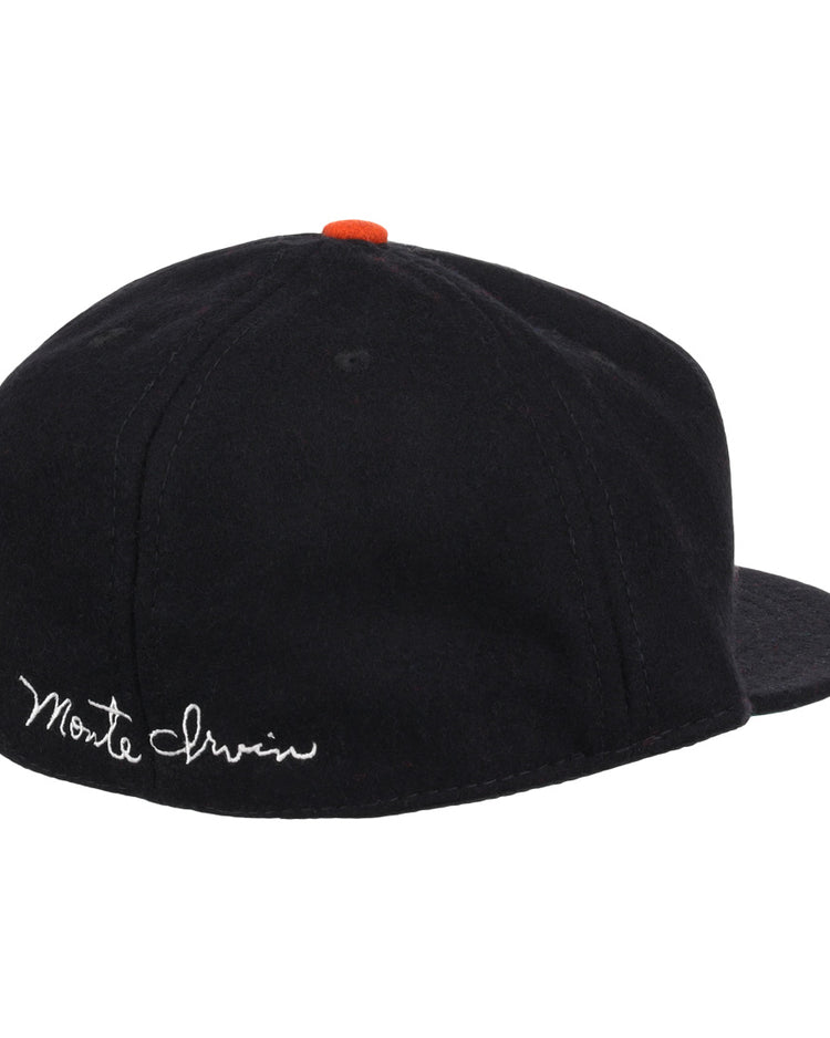 The Ebbets Field Flannels Monte Irvin Signature Series Ballcap is a vintage-style wool cap in black, featuring an orange button and white cursive Monte Irvin embroidery on the back left to honor the Negro National League legend.