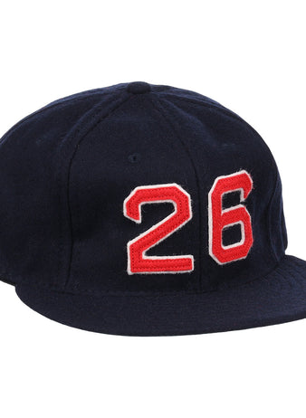 The Ebbets Field Flannels Wade Boggs Signature Series Ballcap is a dark blue vintage wool cap with a red and white number 26 on the front, inspired by classic styles from the National Baseball Hall of Fame.