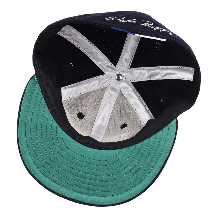 An inside view of the Wade Boggs Signature Series Ballcap by Ebbets Field Flannels features a green brim, black inner band, white stitched panels, and a central button.