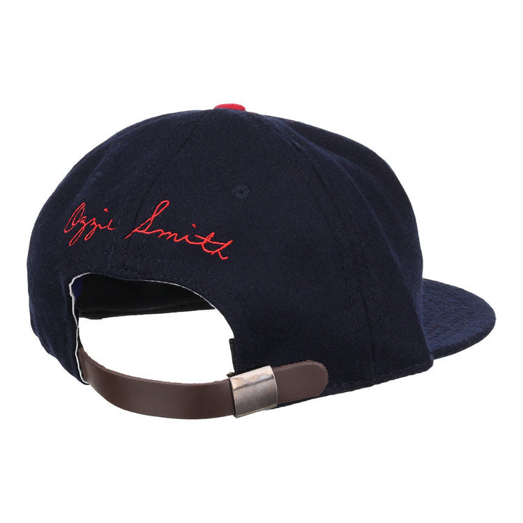 The Ozzie Smith Signature Series Ballcap by Ebbets Field Flannels is a vintage navy wool cap, made in the USA, with a brown adjustable leather strap and Ozzie Smith embroidered in red cursive on the back.