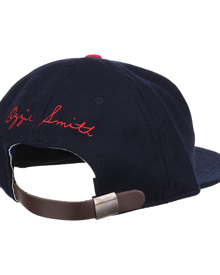 The Ozzie Smith Signature Series Ballcap by Ebbets Field Flannels is a vintage navy wool cap, made in the USA, with a brown adjustable leather strap and Ozzie Smith embroidered in red cursive on the back.