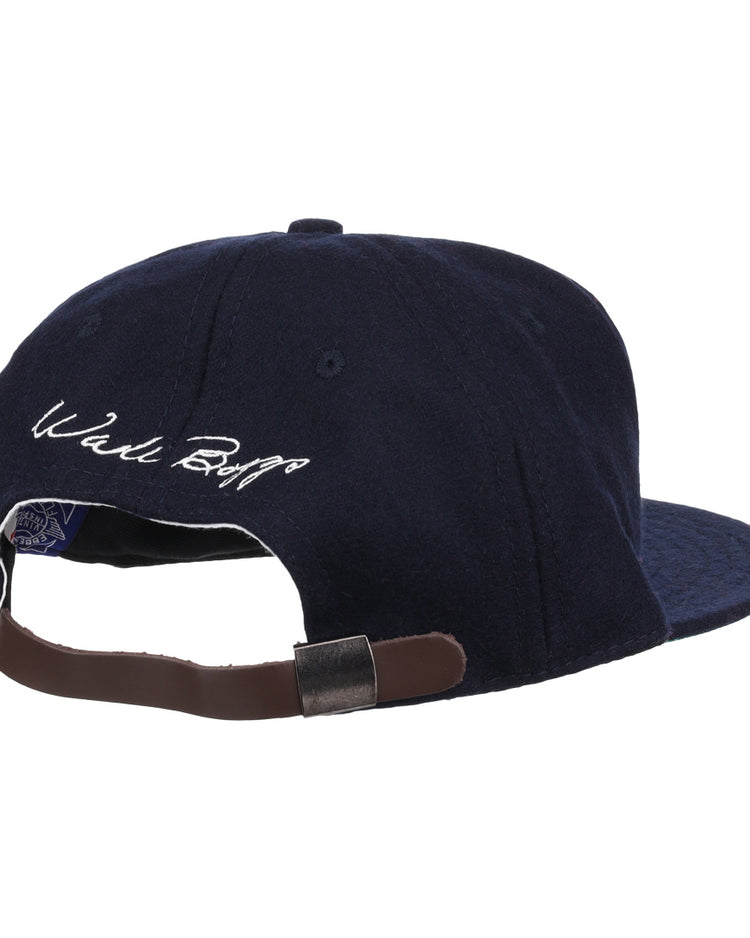 The Ebbets Field Flannels Wade Boggs Signature Series Ballcap in navy wool is shown from the back, featuring a brown adjustable strap and Wade Boggs’s white embroidered signature above the opening.
