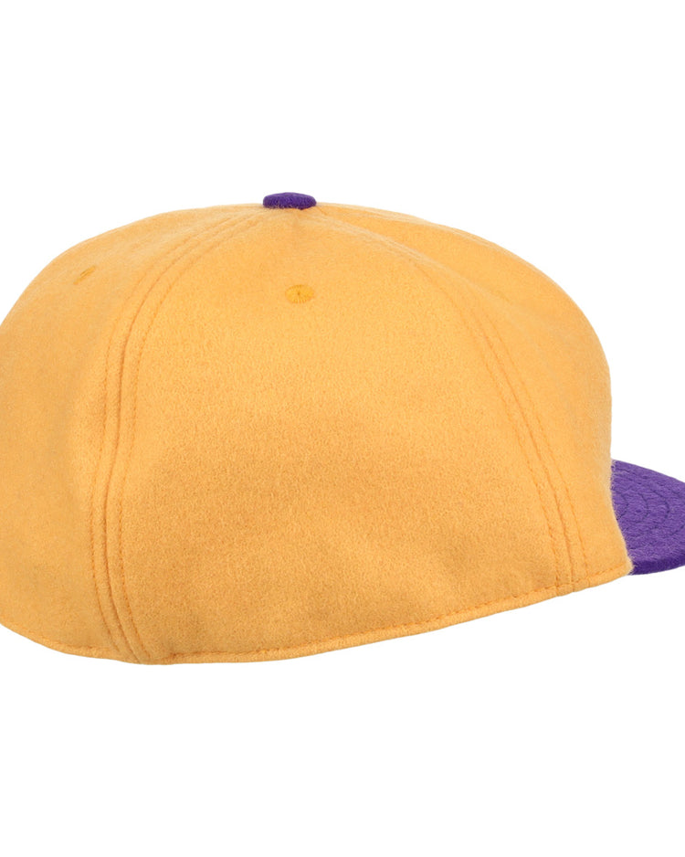 The EFF University of Washington 1936 Rowing Vintage Ballcap in gold features purple brim, visible stitching, and a top button detail, seen from the back and slightly to the side.