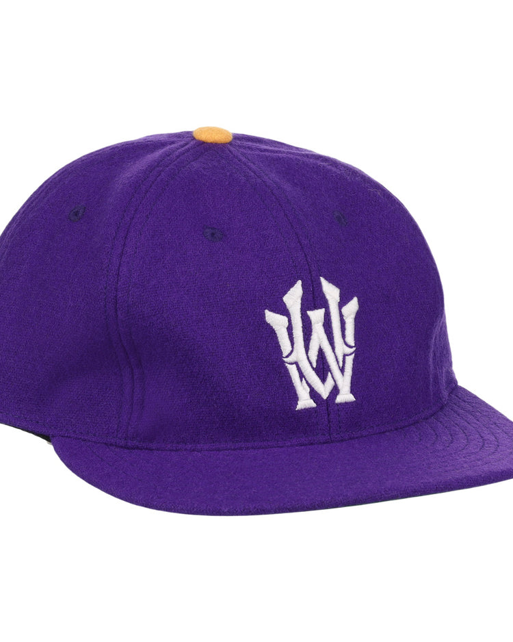 The EFF University of Washington 1936 Rowing Vintage Ballcap is a purple wool cap featuring an official white W logo on the front and a small yellow top button.
