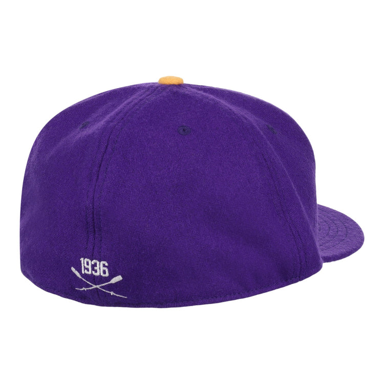 The EFF University of Washington 1936 Rowing Vintage Ballcap features purple wool, a yellow top button, and 1936 with crossed bats embroidered in white on the back—a true collectible for UW fans.