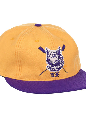 The EFF University of Washington 1936 Rowing Vintage Ballcap features gold wool with a purple brim and button, plus a front dog logo, crossed oars, and 1936 for a classic athletic look.