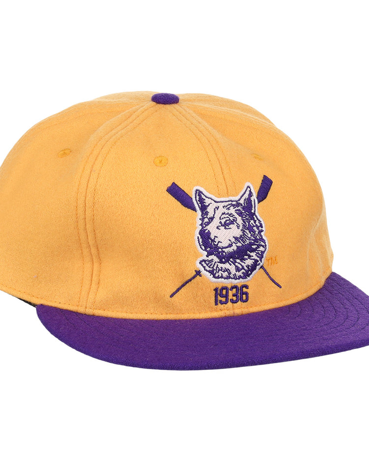 The EFF University of Washington 1936 Rowing Vintage Ballcap features gold wool with a purple brim and button, plus a front dog logo, crossed oars, and 1936 for a classic athletic look.