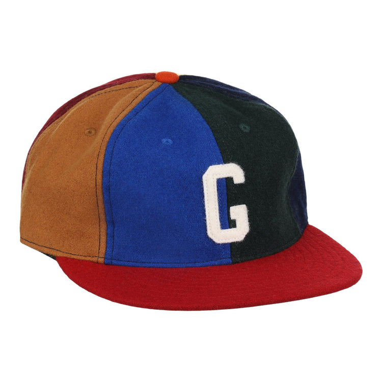 The EFF Homestead Grays Vintage Inspired Pinwheel Ballcap features brown, blue, green, and red panels, a red brim, orange top button, and a bold white G, capturing the classic Negro National League style.