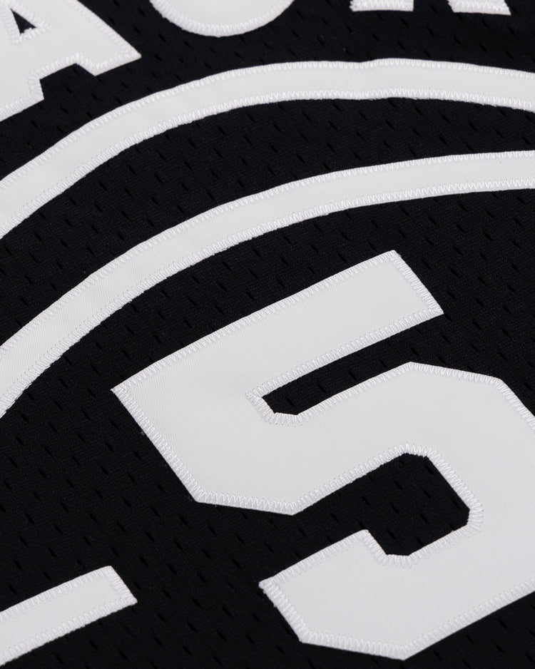 Close-up of the Black Fives Basketball Jersey by EFF, showcasing white stitched numbers—prominently the large number 5—and curved lines, honoring Black basketball heritage.