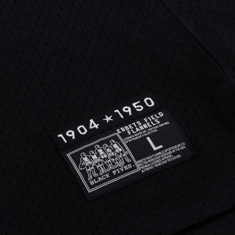 The EFF Black Fives Basketball Jersey features black mesh fabric and a rectangular patch with 1904 ★ 1950, Ebbets Field Flannels, Black Fives, five Black basketball players, size L, and care instructions.