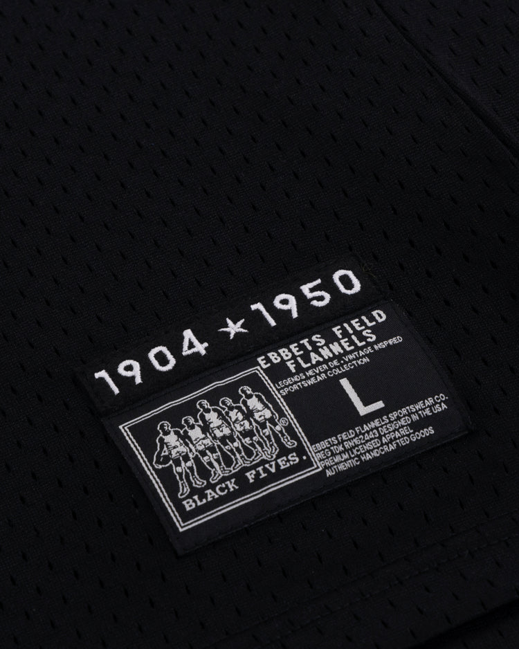 The EFF Black Fives Basketball Jersey features black mesh fabric and a rectangular patch with 1904 ★ 1950, Ebbets Field Flannels, Black Fives, five Black basketball players, size L, and care instructions.
