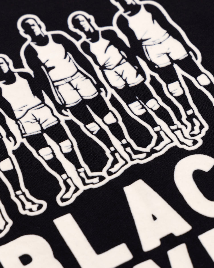 Illustration of six athletes in tank tops and shorts, with bold WHITE BLACK text beneath on a dark background—celebrating Black basketball history. Featured: Black Fives T-Shirt by Ebbets Field Flannels.