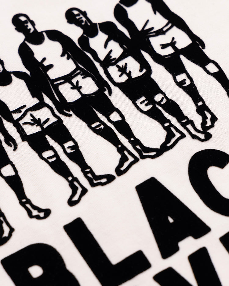 Close-up of a printed design on a white Ebbets Field Flannels Black Fives T-Shirt, featuring Black men in sportswear celebrating basketball history above large bold BLACK lettering.