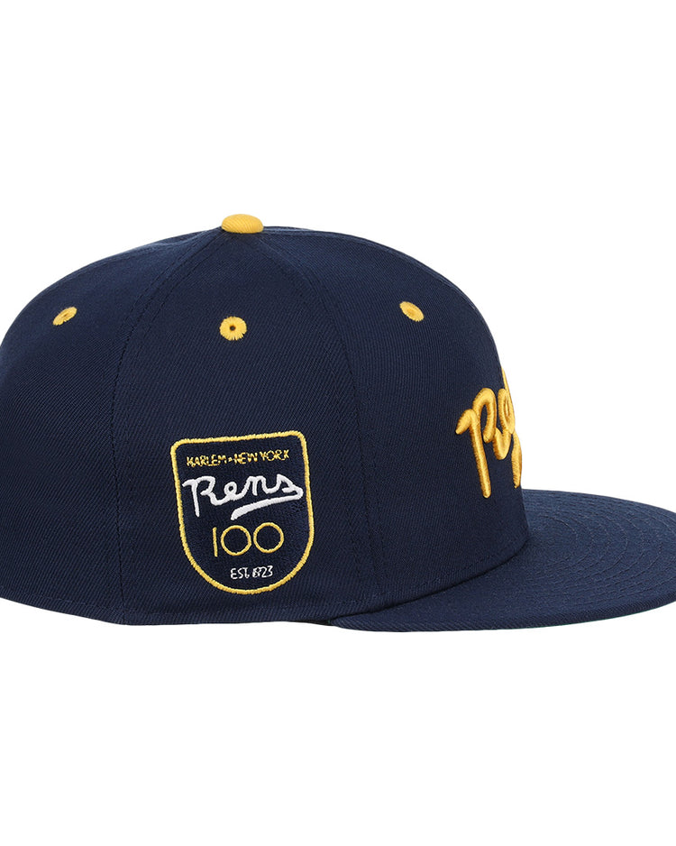 The New York Rens Fitted Ballcap by Ebbets Field Flannels is a navy cap with yellow “Rens” script on the front and a Harlem-New York Rens 100 Est. 1922 side patch, honoring Black basketball history.