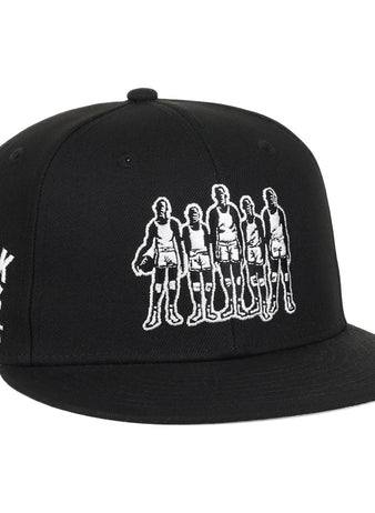 The Black Fives Fitted Ballcap by Ebbets Field Flannels features an embroidered outline of five vintage basketball players and BLACK FIVES BASKETBALL 1904-1950 on the side, honoring Black Fives history and Ebbets Field Flannels heritage.