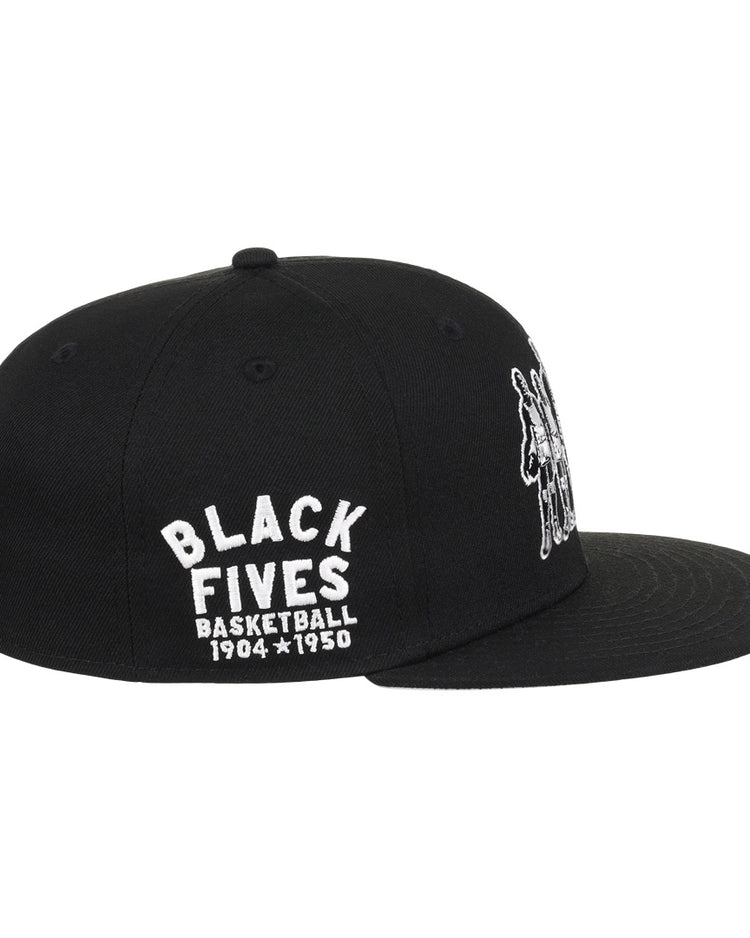 The Black Fives Fitted Ballcap by Ebbets Field Flannels is a black cap with white BLACK FIVES BASKETBALL 1904-1950 embroidery on the side and a small image of Black basketball players on the front.