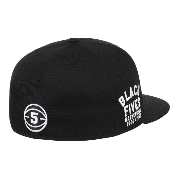 The Black Fives Fitted Ballcap by Ebbets Field Flannels is a black cap with white “BLACK FIVES BASKETBALL 1904-1970s” embroidery on the side and a circular 5 logo on the back, celebrating Black basketball history.