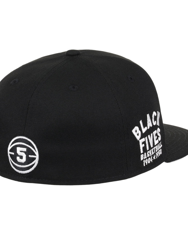 The Black Fives Fitted Ballcap by Ebbets Field Flannels is a black cap with white “BLACK FIVES BASKETBALL 1904-1970s” embroidery on the side and a circular 5 logo on the back, celebrating Black basketball history.