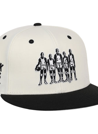 The Ebbets Field Flannels Black Fives Snapback Ballcap features an illustration of five vintage basketball players on the front and BLACK FIVES BASKETBALL 1904–1950 embroidered on the side, celebrating Black basketball history.