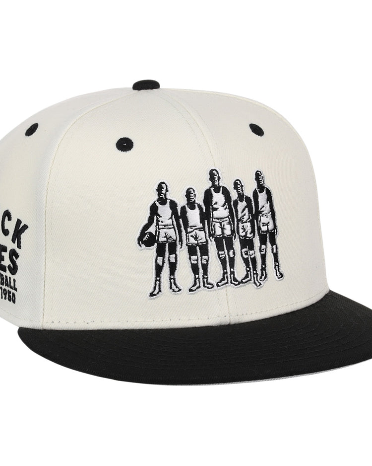 The Ebbets Field Flannels Black Fives Snapback Ballcap features an illustration of five vintage basketball players on the front and BLACK FIVES BASKETBALL 1904–1950 embroidered on the side, celebrating Black basketball history.