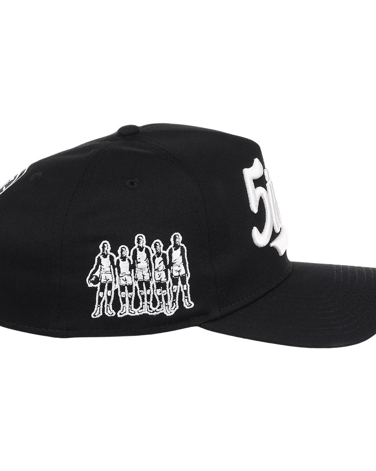The Black Fives Snapback A-Frame by Ebbets Field Flannels features a black design with a white outline of five standing figures and a bold white 50 embroidered on the front, honoring Black basketball history.